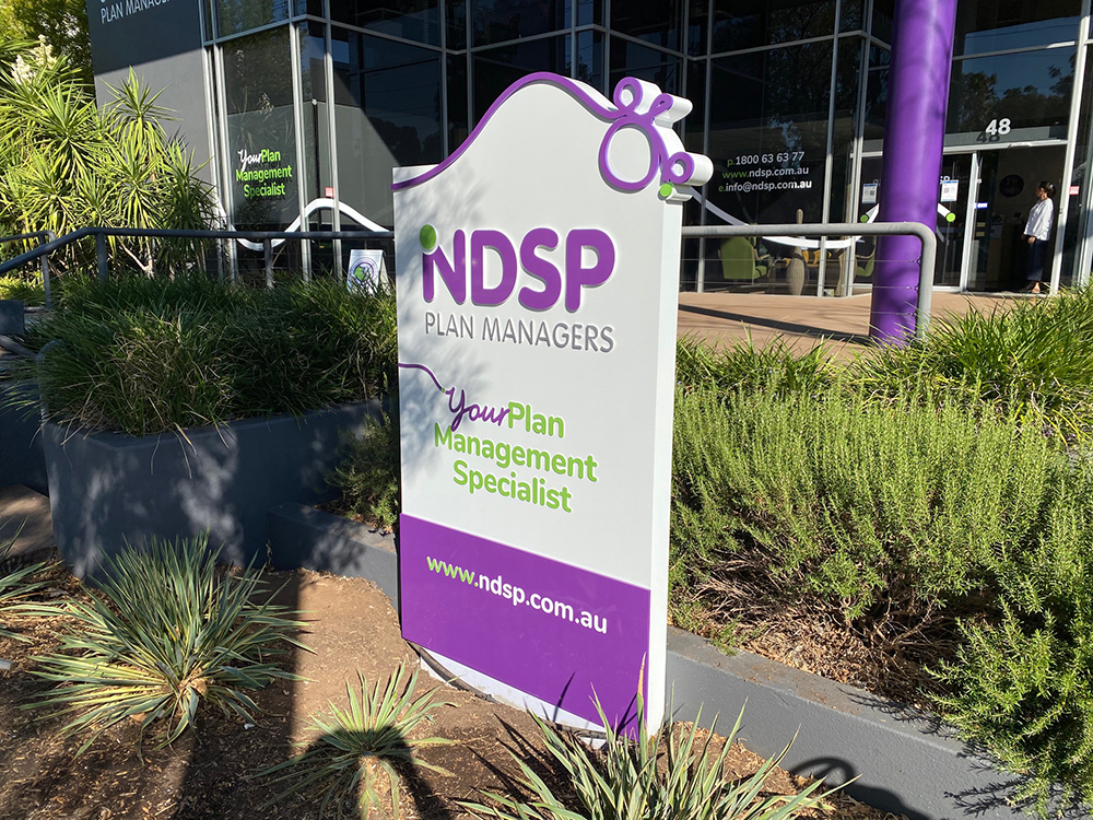 freestanding exterior sign with purple and green colouring